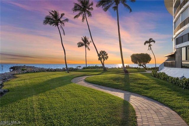 2301 Gulf Shore Blvd N Unit 114, Naples, FL 34103 - view of property's community with a water view and a yard