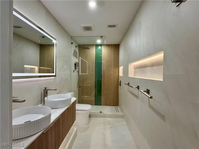 780 Augusta Blvd Unit C204, Naples, FL 34113 - bathroom featuring toilet, a shower stall, and double vanity