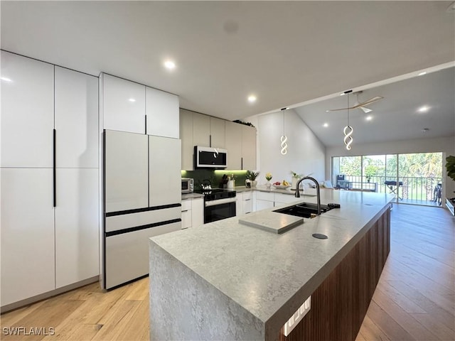 780 Augusta Blvd Unit C204, Naples, FL 34113 - kitchen with stainless steel microwave, black electric range oven, light wood-type flooring, modern cabinets, and a sink