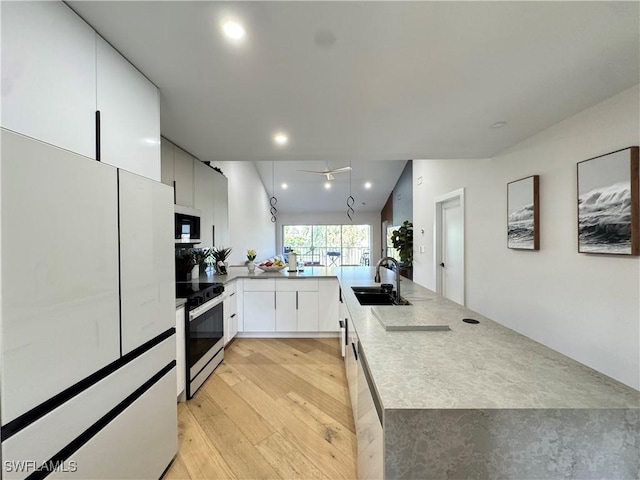 780 Augusta Blvd Unit C204, Naples, FL 34113 - kitchen with freestanding refrigerator, electric stove, a sink, stainless steel microwave, and light wood-type flooring