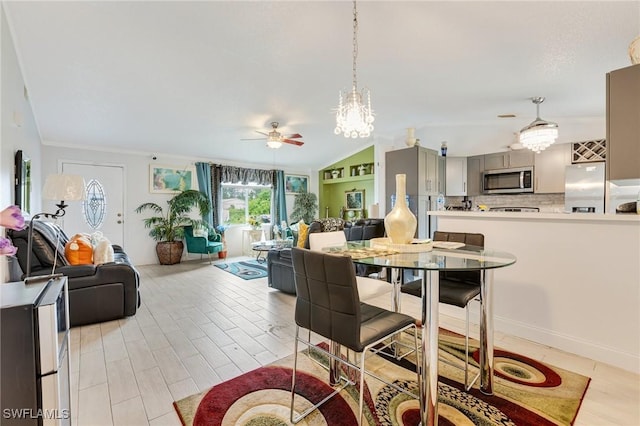 503 E 13th St, Lehigh Acres, FL 33972 - dining room featuring ceiling fan, a chandelier, and vaulted ceiling