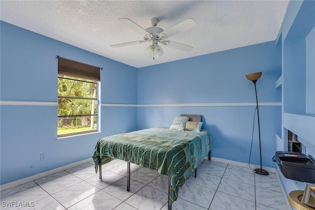 503 E 13th St, Lehigh Acres, FL 33972 - bedroom with a textured ceiling, ceiling fan, and baseboards