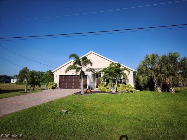 406 SW 25th Pl, Cape Coral, FL 33991 - ranch-style house with decorative driveway, a front yard, and a garage