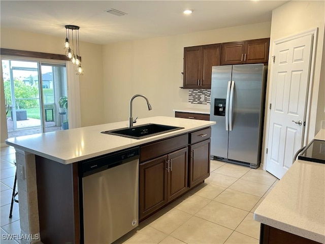 406 SW 25th Pl, Cape Coral, FL 33991 - kitchen featuring stainless steel appliances, a sink, light countertops, light tile patterned floors, and pendant lighting