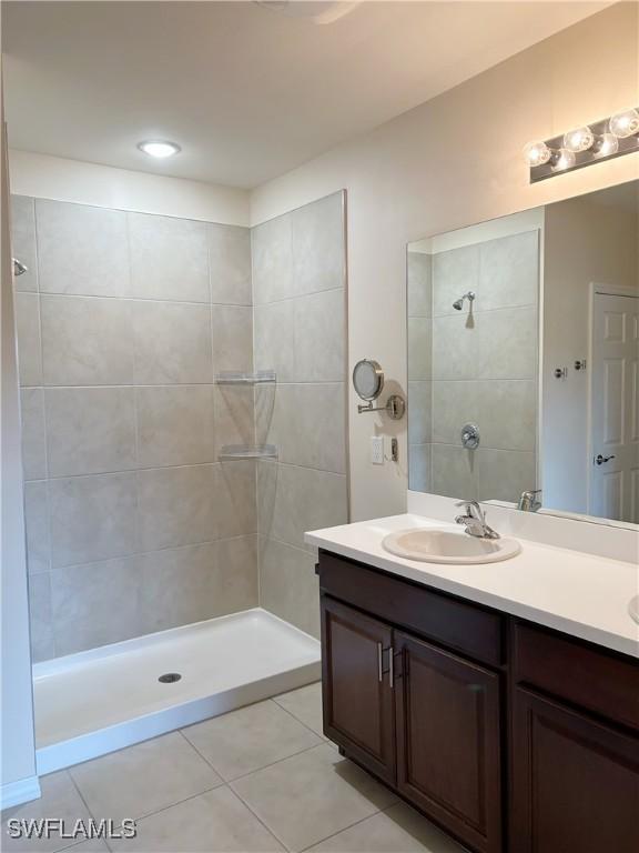 406 SW 25th Pl, Cape Coral, FL 33991 - bathroom with tile patterned floors, double vanity, and a tile shower