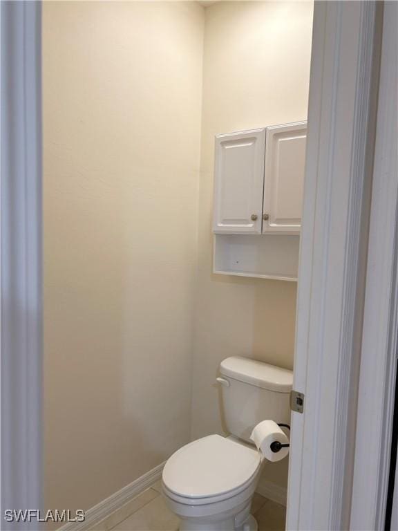 406 SW 25th Pl, Cape Coral, FL 33991 - bathroom featuring baseboards, toilet, and tile patterned floors