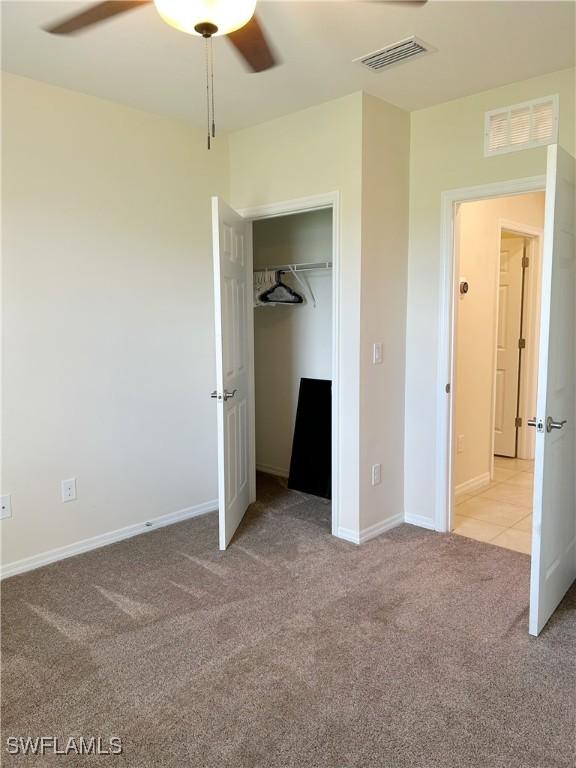 406 SW 25th Pl, Cape Coral, FL 33991 - unfurnished bedroom featuring light colored carpet, a ceiling fan, baseboards, and a closet