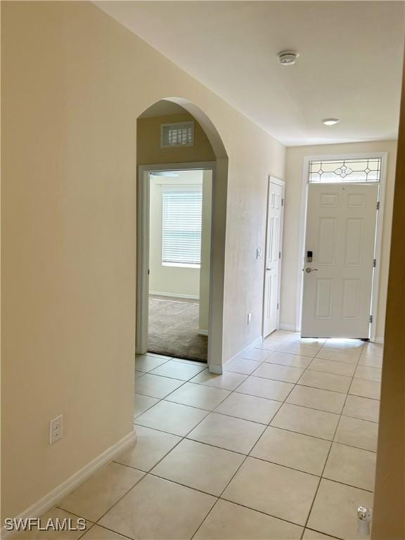 406 SW 25th Pl, Cape Coral, FL 33991 - entryway with light tile patterned floors, arched walkways, and baseboards