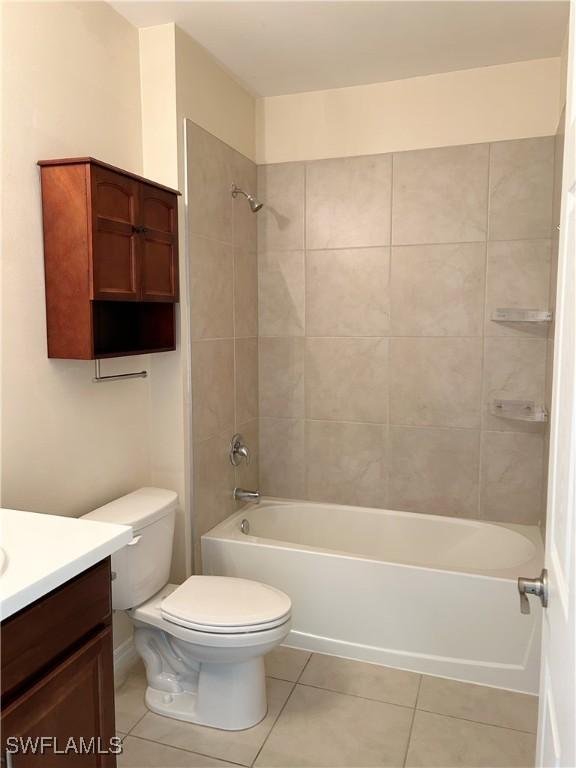 406 SW 25th Pl, Cape Coral, FL 33991 - bathroom featuring tile patterned floors, toilet, vanity, and shower / tub combination