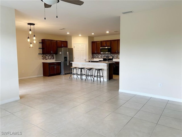 406 SW 25th Pl, Cape Coral, FL 33991 - kitchen featuring appliances with stainless steel finishes, tasteful backsplash, light countertops, light tile patterned floors, and recessed lighting