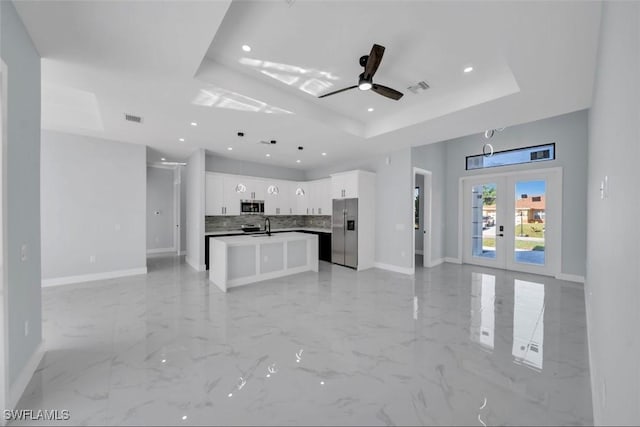 1820 Marson St, Lehigh Acres, FL 33972 - unfurnished living room with a raised ceiling, baseboards, french doors, a sink, and ceiling fan