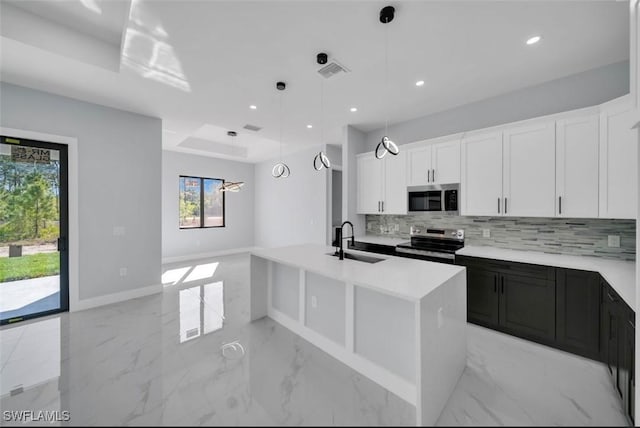 1820 Marson St, Lehigh Acres, FL 33972 - kitchen with appliances with stainless steel finishes, a sink, backsplash, light countertops, and light marble finish floors
