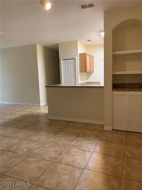 6169 Metrowest Blvd Unit 104, Orlando, FL 32835 - spare room featuring light tile patterned floors and baseboards