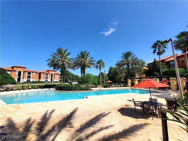 6169 Metrowest Blvd Unit 104, Orlando, FL 32835 - community pool featuring a patio area