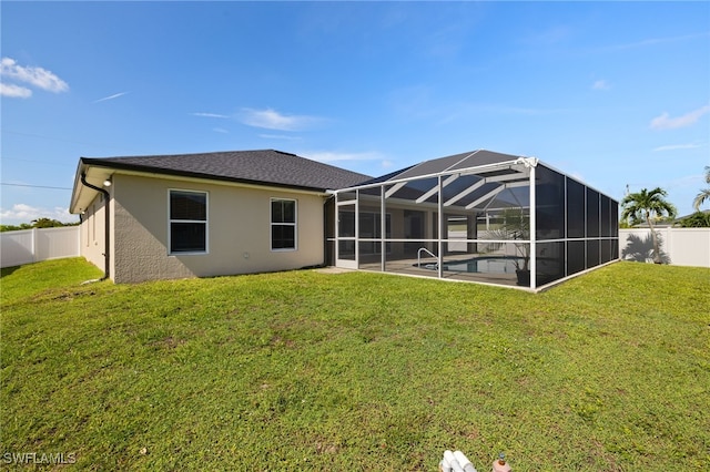 2933 NW 25th Ter, Cape Coral, FL 33993 - rear view of house with a fenced backyard, stucco siding, glass enclosure, and a patio area