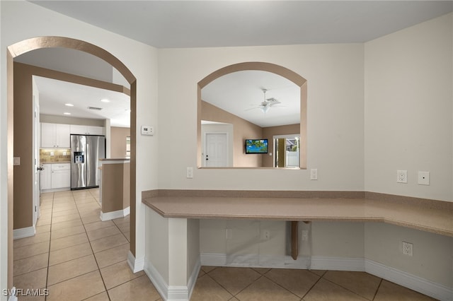 2933 NW 25th Ter, Cape Coral, FL 33993 - hall with light tile patterned flooring, arched walkways, recessed lighting, and vaulted ceiling