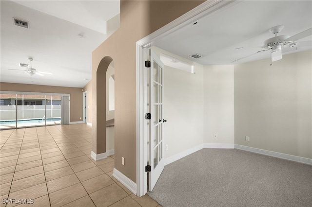2933 NW 25th Ter, Cape Coral, FL 33993 - tiled spare room with ceiling fan, arched walkways, and a baseboard heating unit