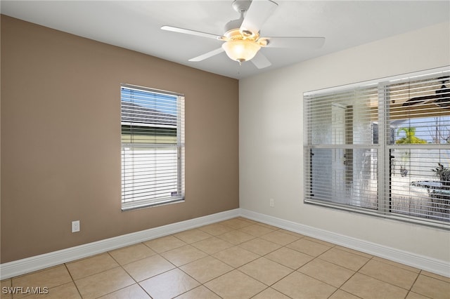 2933 NW 25th Ter, Cape Coral, FL 33993 - empty room with plenty of natural light, light tile patterned floors, and ceiling fan