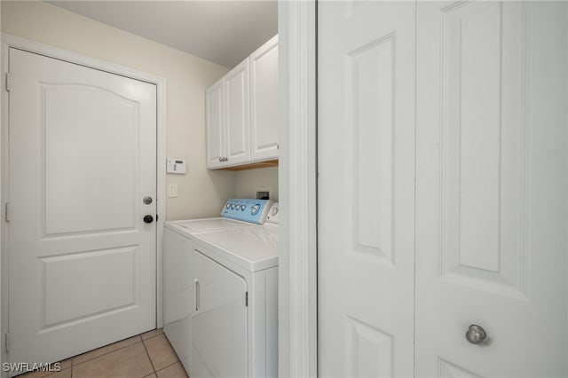 2933 NW 25th Ter, Cape Coral, FL 33993 - laundry room with cabinet space, washing machine and dryer, and light tile patterned floors