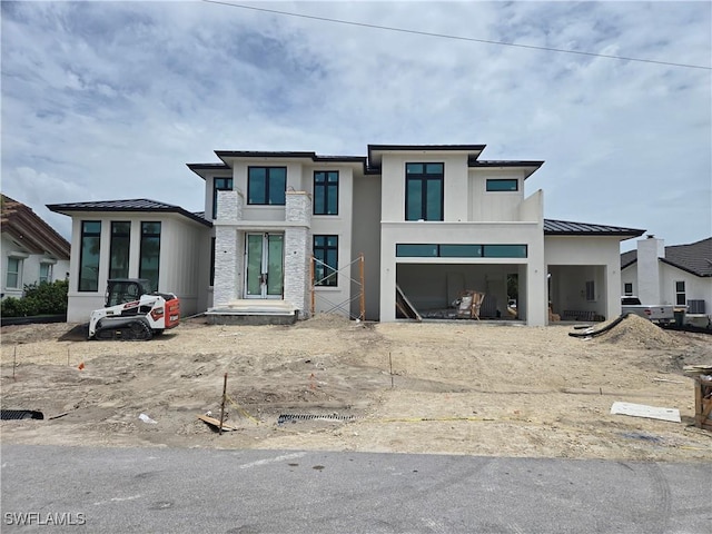 109 S Seas Ct, Marco Island, FL 34145 - view of front of home featuring a standing seam roof, metal roof, stucco siding, and an attached garage