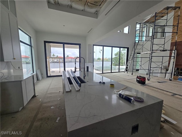 109 S Seas Ct, Marco Island, FL 34145 - kitchen featuring white cabinets and a high ceiling