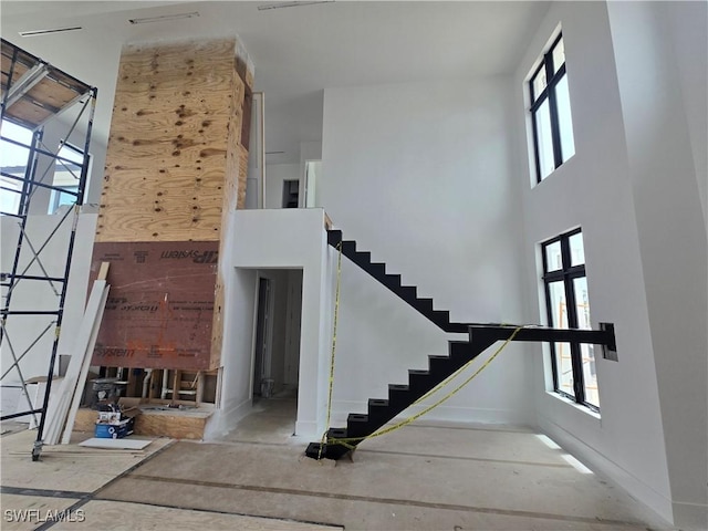 109 S Seas Ct, Marco Island, FL 34145 - stairs featuring a towering ceiling and baseboards