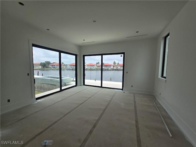 109 S Seas Ct, Marco Island, FL 34145 - empty room with a water view, concrete flooring, and baseboards