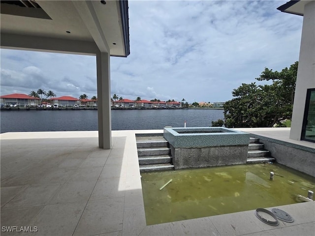 109 S Seas Ct, Marco Island, FL 34145 - view of patio featuring a water view and an outdoor hot tub