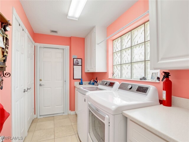 28979 Vermillion Ln, Bonita Springs, FL 34135 - laundry room featuring cabinet space, washing machine and dryer, and light tile patterned floors