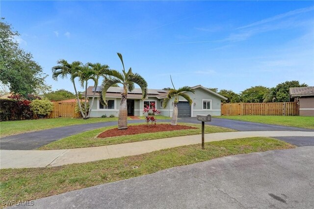 5530 SW 113th Ave, Cooper City, FL 33330 - single story home with driveway, solar panels, an attached garage, and stucco siding