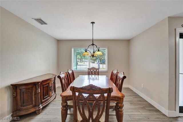 5530 SW 113th Ave, Cooper City, FL 33330 - dining room with a chandelier, baseboards, and light wood-style flooring
