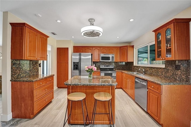 5530 SW 113th Ave, Cooper City, FL 33330 - kitchen featuring appliances with stainless steel finishes, a sink, glass insert cabinets, backsplash, and dark stone counters