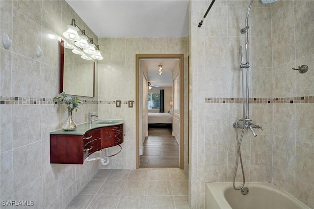 5530 SW 113th Ave, Cooper City, FL 33330 - full bath featuring connected bathroom, vanity, tile patterned floors,  shower combination, and tile walls
