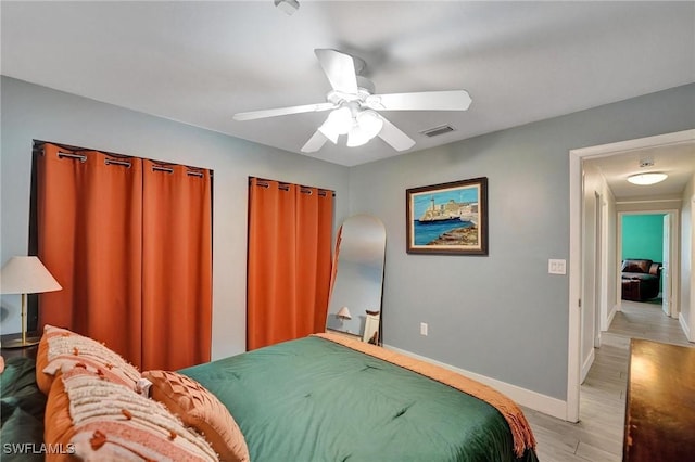 5530 SW 113th Ave, Cooper City, FL 33330 - bedroom with light wood finished floors, baseboards, and a ceiling fan