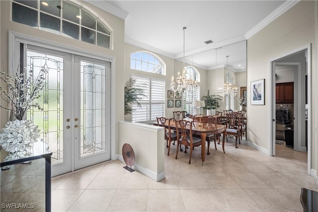 8423 Gleneagle Way, Naples, FL 34120 - foyer entrance featuring ornamental molding, french doors, a chandelier, and light tile patterned flooring
