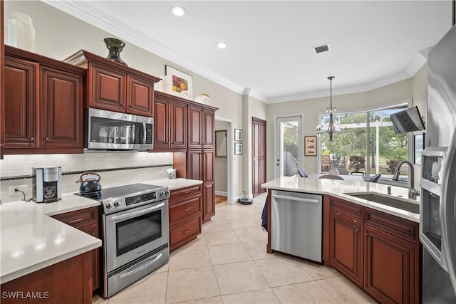 8423 Gleneagle Way, Naples, FL 34120 - kitchen with appliances with stainless steel finishes, light countertops, backsplash, recessed lighting, and pendant lighting