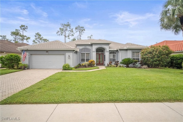 8423 Gleneagle Way, Naples, FL 34120 - view of front of property featuring french doors, an attached garage, a front lawn, stucco siding, and decorative driveway