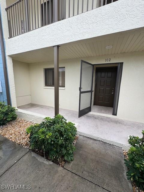 3911 Country Club Blvd Unit 102, Cape Coral, FL 33904 - doorway to property with stucco siding