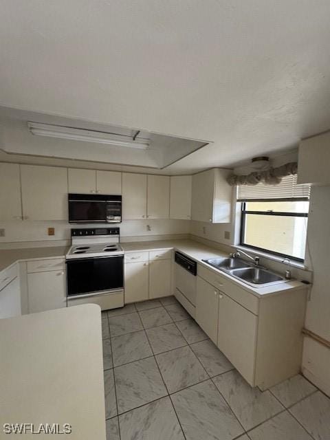 3911 Country Club Blvd Unit 102, Cape Coral, FL 33904 - kitchen with white appliances, a sink, light countertops, a tray ceiling, and cream cabinetry