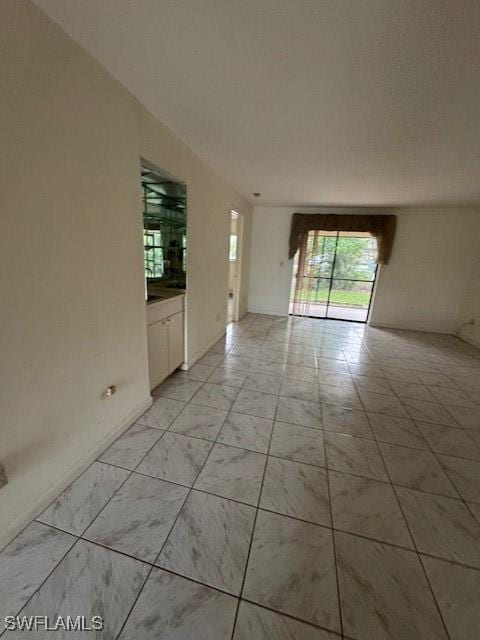 3911 Country Club Blvd Unit 102, Cape Coral, FL 33904 - empty room with light marble finish flooring and baseboards