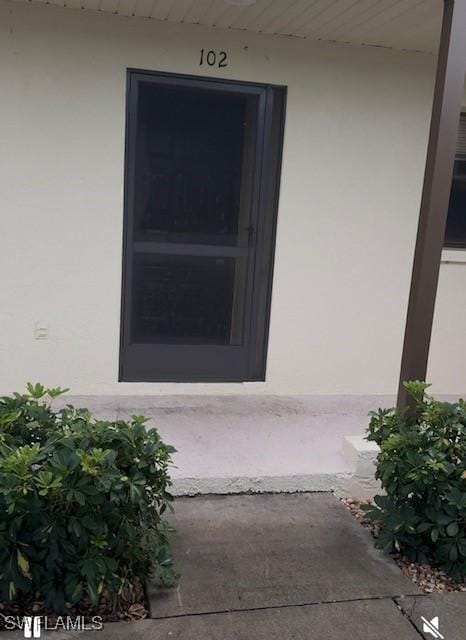 3911 Country Club Blvd Unit 102, Cape Coral, FL 33904 - property entrance featuring stucco siding