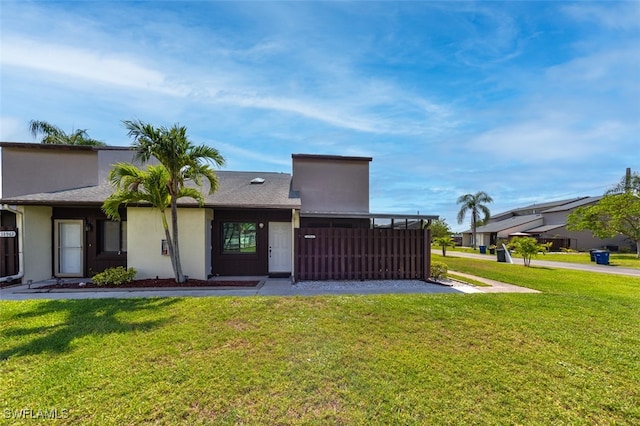 12964 Meadowood Ct, Fort Myers, FL 33919 - rear view of property with a yard and stucco siding