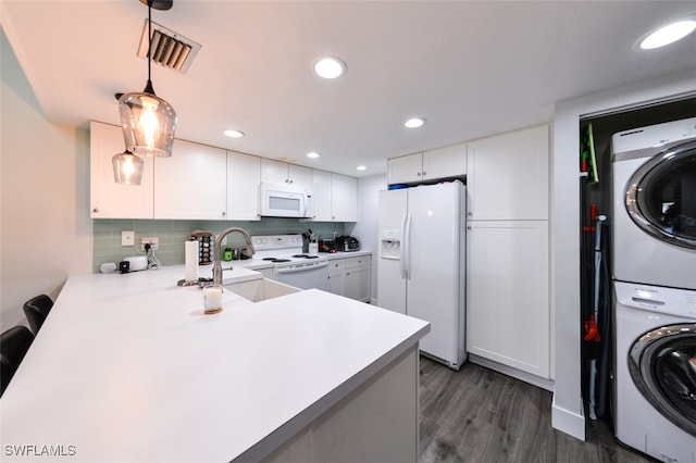 12964 Meadowood Ct, Fort Myers, FL 33919 - kitchen featuring white appliances, stacked washer / drying machine, light countertops, a sink, and tasteful backsplash