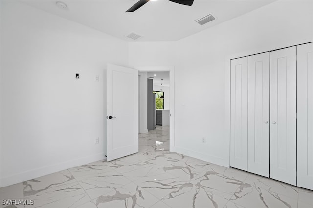 133 Fox Ave S, Lehigh Acres, FL 33974 - unfurnished bedroom featuring light marble finish flooring, baseboards, and ceiling fan