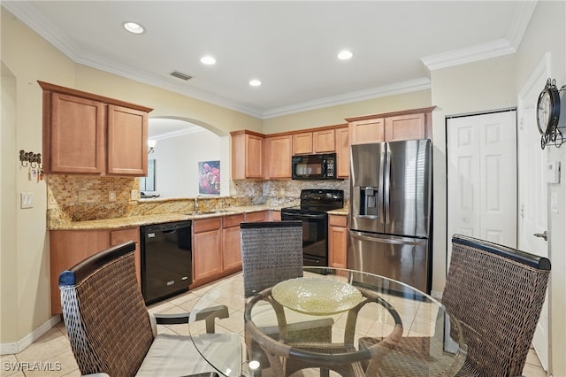 10020 Ravello Blvd, Fort Myers, FL 33905 - kitchen with black appliances, a sink, decorative backsplash, arched walkways, and recessed lighting