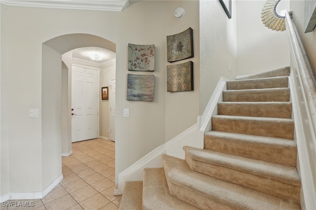 10020 Ravello Blvd, Fort Myers, FL 33905 - stairway with arched walkways, crown molding, tile patterned floors, and baseboards