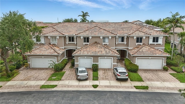 10020 Ravello Blvd, Fort Myers, FL 33905 - view of front of house with stucco siding, a tile roof, and driveway