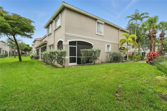 10020 Ravello Blvd, Fort Myers, FL 33905 - back of property featuring stucco siding and a lawn
