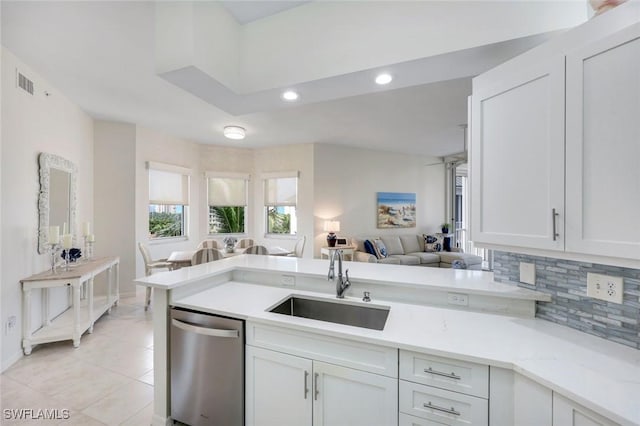 460 Launch Cir Ph 01, Naples, FL 34108 - kitchen with dishwasher, a sink, open floor plan, tasteful backsplash, and white cabinetry