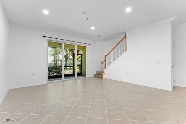 4381 Lazio Way Unit 501, Fort Myers, FL 33901 - unfurnished living room with recessed lighting, stairs, baseboards, and light tile patterned flooring